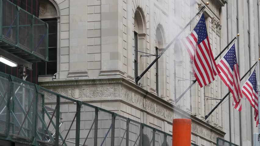 New York City United States. Manhattan Downtown Financial District urban architecture. American Flag on Wall street near Stock Exchange, Federal Hall building, USA Stock Market. Hot steam smoke stack.