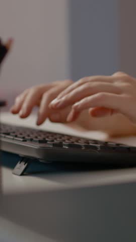 Vertical Screen: Close up of a woman hands typing on a keyboard at her home office, focused on her work as a freelancer, showcasing her remote job routine and productivity.