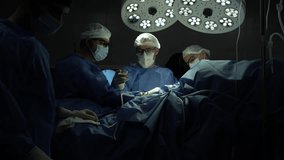 Surgical team performing operation under bright lights - Powered by Shutterstock - Get 15% off with code: PIKWIZARD15