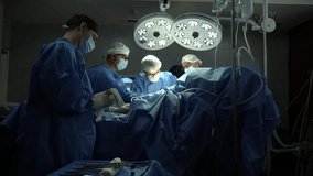 Surgical team performing operation under bright lights - Powered by Shutterstock - Get 15% off with code: PIKWIZARD15