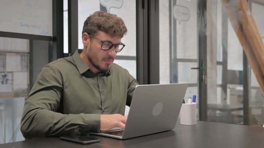 Middle Aged Man with Headache at Work