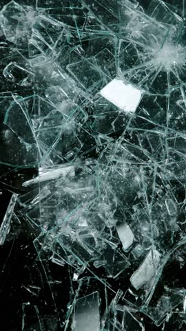 Super slow motion of broken glass, shattering against black background . Filmed on high speed cinema camera, 1000 fps.