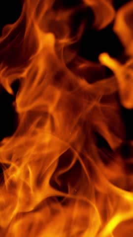 Super Slow Motion Shot of Burning Fire Flames isolated on Black Background . Filmed on High Speed Cinematic Camera at 1000 FPS .