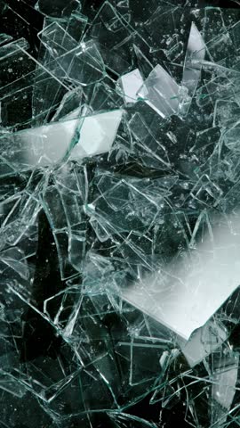 Super slow motion of broken glass, shattering against black background . Filmed on high speed cinema camera, 1000 fps.