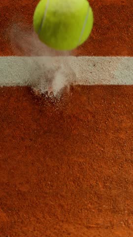 Super Slow Motion Detail Shot of Tennis Ball Hitting a Clay Court . Filmed on High Speed Cinematic Camera at 1000 fps