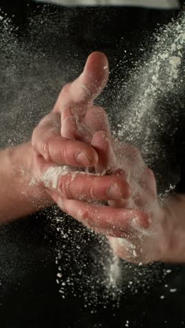 Super Slow Motion Chef Clapping Hands with Flour . Filmed on High Speed Cinema Camera, 1000 fps . Closeup of Bread or Pizza Dough Preparation