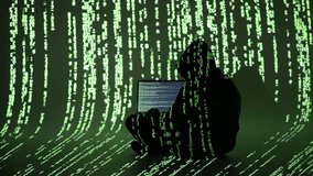 A cybercriminal in a hooded outfit types on a laptop surrounded by digital green code. This immersive matrix-style scene reflects cybercrime, hacking, and data breaches in progress - Powered by Shutterstock - Get 15% off with code: PIKWIZARD15
