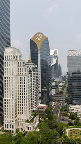 BANGKOK, THAILAND - 9 MARCH 2025 : timelapse of the Bangkok city skyline from a high vantage point in vertical