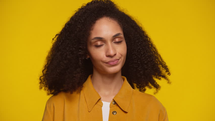 Young Woman Shaking Head in Disapproval on Yellow