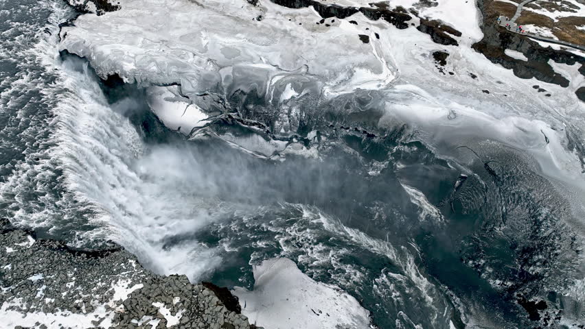 Aerial tracking overview of the icy Dettifoss waterfall, overcast day in Iceland