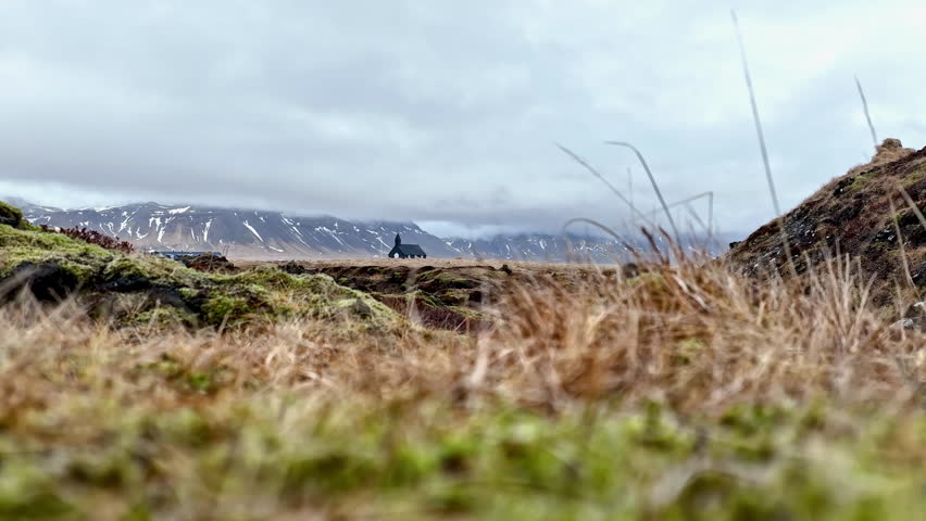 Aerial view of mossy nature and the Buoakirkja church, in Buoahraun, Iceland