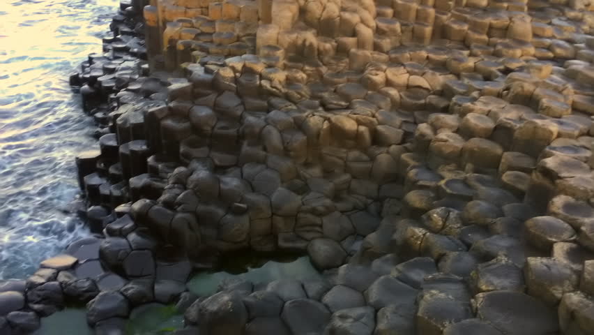 Smooth pan across the honey comb hexagonal steps at giants causeway