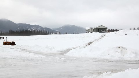 Man slipping on ice on a ranch in Montana
