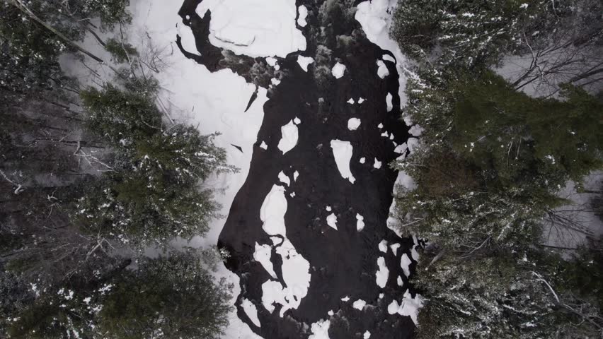 A drone flyover shot of the West Branch Ausable River at the base of Whiteface Mountain, Adirondack Mountains in upstate NY during Midwinter
