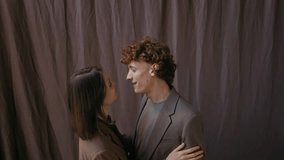 Close-up shot of romantic couple slow dancing to music in room against dark brown curtains at home - Powered by Shutterstock - Get 15% off with code: PIKWIZARD15