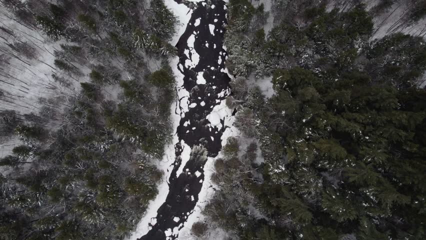 A drone flyover shot of the West Branch Ausable River at the base of Whiteface Mountain, Adirondack Mountains in upstate NY during Midwinter