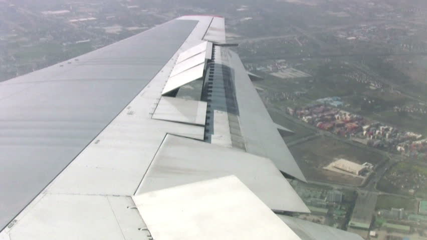 View from the airplane on the industrial area of the city. The plane makes a