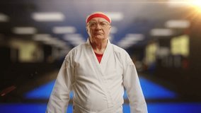 Senior man in martial arts uniform bowing before sparring on gym background - Powered by Shutterstock - Get 15% off with code: PIKWIZARD15