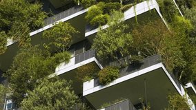 Close up of vertical forest building with lush greenery and trees integrated into modern architecture, Milan, Italy. Vertical garden and landscaping, innovative architecture, urban sustainability - Powered by Shutterstock - Get 15% off with code: PIKWIZARD15