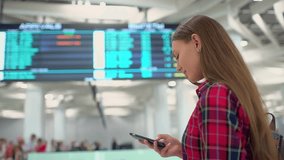 Traveler tourist woman airport airport mobile phone, checks departures arrivals board searching scoreboard flight information. Passenger with backpack check in at departure terminal, travel, tourism - Powered by Shutterstock - Get 15% off with code: PIKWIZARD15