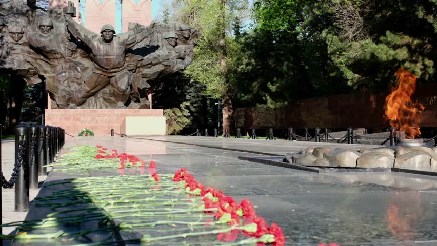 April 15, 2025 Almaty, Kazakhstan. The Monument to the defenders of Moscow during the Great Patriotic War is a monument to 28 Panfilov heroes and an eternal flame with flowers.