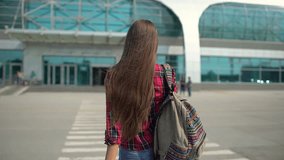 Traveler tourist woman entrance to airport backpack walking carrying luggage baggage backpack and pulling rolling suitcase, passenger in terminal, travel, tourism, transportation, departures.  - Powered by Shutterstock - Get 15% off with code: PIKWIZARD15