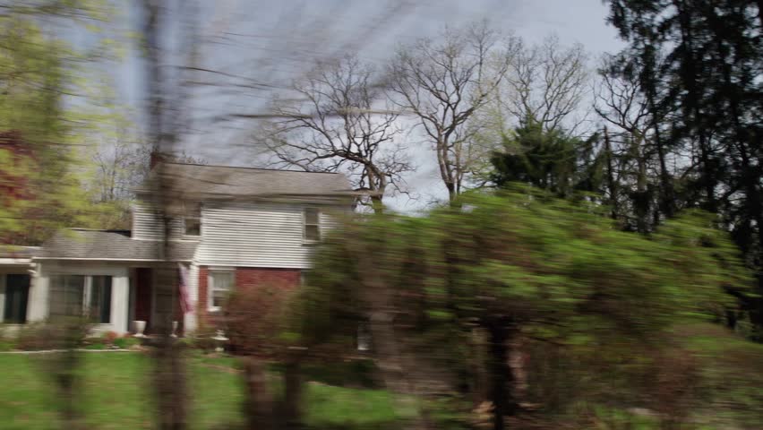 Moving past Pittsburgh, PA greater area suburbs and neighborhood homes in western Pennsylvania in warm, sunny spring weather in April of residential areas in North Hills suburban roads and houses