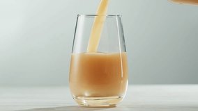 Apple pear juice or cider is pouring from a bottle into a glass. Fresh drink with apples and pear on an old kitchen table.  - Powered by Shutterstock - Get 15% off with code: PIKWIZARD15