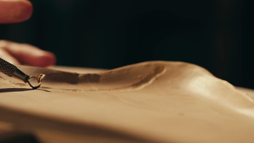Woman potter works with clay on master class in studio. Working process in ceramic workshop. Potter making vase on pottery wheel. Handmade concept. 
