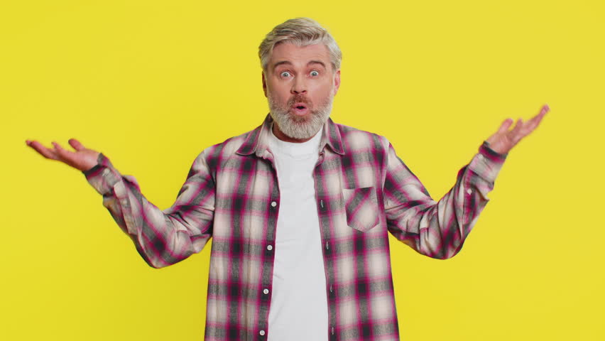 Caucasian middle-aged mature man on yellow background experiencing mind explosion, bright aha moment. Intellectual breakthrough unexpected solution strong brainstorming reaction excited face gesture