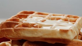 Belgian waffles sprinkled with powdered sugar with condensed milk top view on a white background with copy space - Powered by Shutterstock - Get 15% off with code: PIKWIZARD15