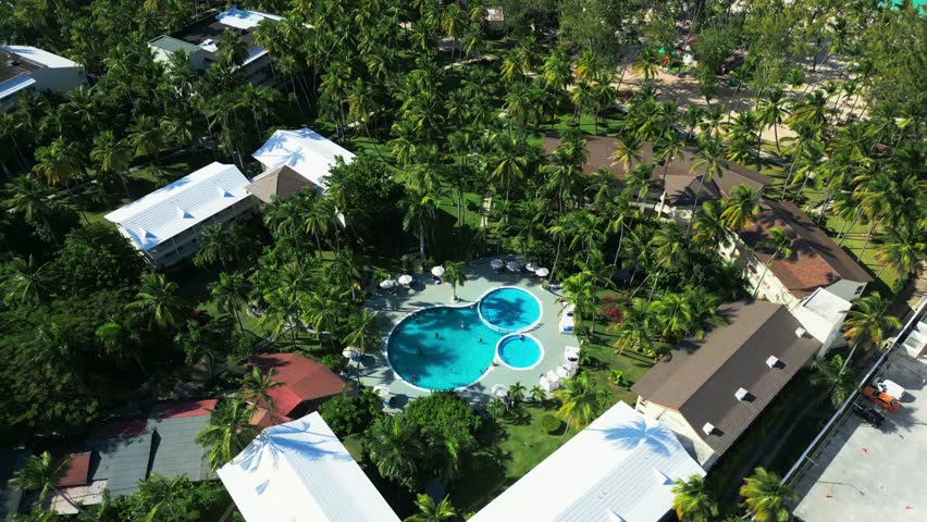 Flight around a tourist swimming pool located at an all-inclusive hotel