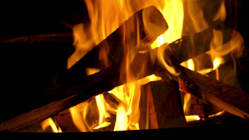 Flame of fire at bonfire in the dark, closeup