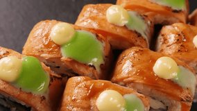 Sushi rolls on black platter, closeup. Japanese cuisine. Rotating - Powered by Shutterstock - Get 15% off with code: PIKWIZARD15