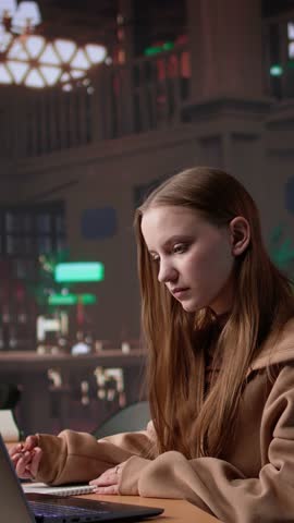 Vertical Video Academic student working on diploma essay in a calm library environment, employing mixed educational database on campus. Dedication and strong focus on achieving intellectual goals