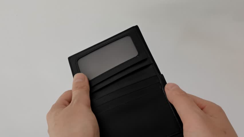 Empty Wallet Opened with Hands Against a White Wall Emblazoned with Hand Shadow.not have budget of money to pay no have credit card, not able payment bill, loan or expense with bank, bankruptcy