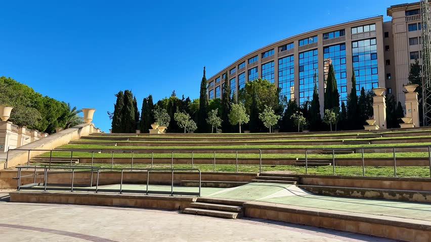 This is a beautifully picturesque view of a modern green space, which is surrounded by elegant architecture