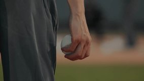 Focused Baseball Player Holding the Ball in Hand While Preparing to Pitch, Capturing the Intensity and Anticipation of the Game in a Close-Up Athletic Moment - Powered by Shutterstock - Get 15% off with code: PIKWIZARD15