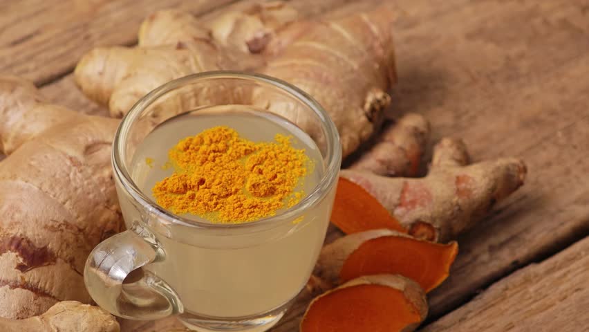 Healthy turmeric water on background