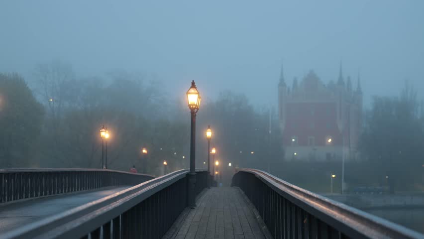 Stockholm, Sweden A man walks on a foggy night on the Skeppsholmen bridge in downtown. 
