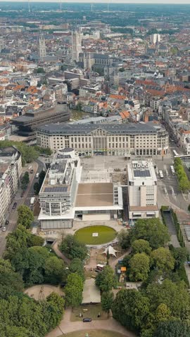 Vertical video. Ghent, Belgium. Panorama of the central city from the air. Cloudy weather, summer day, Aerial View, Departure of the camera