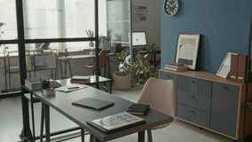 No people shot of sleek, organized office with minimalist grey furniture, indoor plants, and clean aesthetic, ideal for productivity and professional meetings - Powered by Shutterstock - Get 15% off with code: PIKWIZARD15