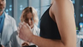 In sports lab team of scientists monitoring female athlete running on treadmill. Physical endurance. Sport and technology. Data center. High-tech office. - Powered by Shutterstock - Get 15% off with code: PIKWIZARD15