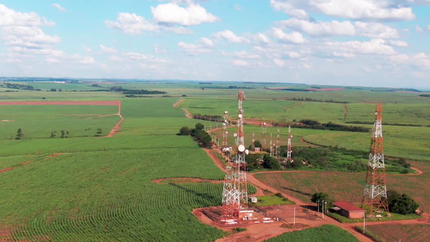 Drone aerial landscape of communication towers antenna network system structures in rural farmland countryside Brazil infrastructure broadcast technology internet satellite