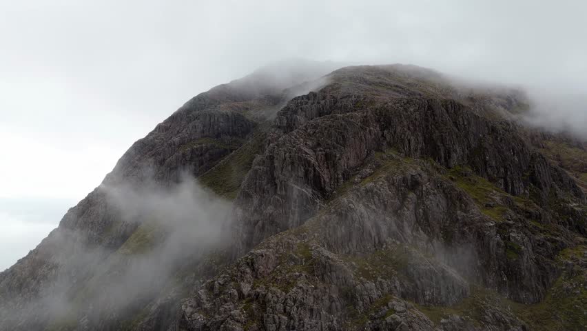 Aerial drone footage of the mountain top in Glencoe mountain range in the Scottish Highlands, taken in summer