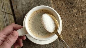 Woman drinking coffee. Hand stirring sugar in a mug of espresso coffee. Top view. - Powered by Shutterstock - Get 15% off with code: PIKWIZARD15