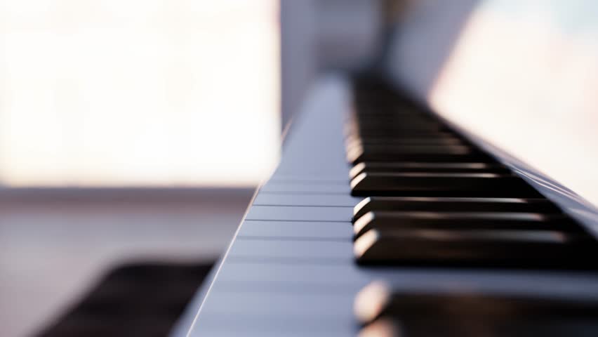 Close up view of a white grand piano keyboard changing perspective in a bright room