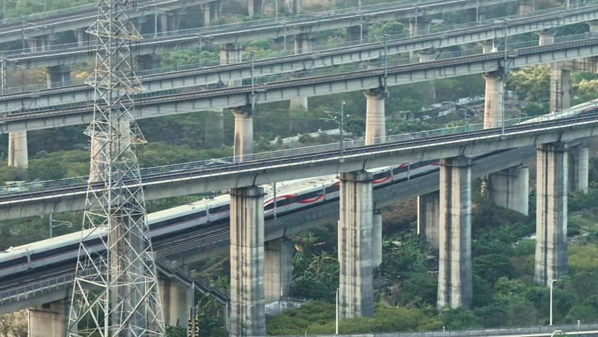 Chinese suburban train going over bridge rail road. Fast china railway transport. Multi level railroad. Aerial drone view. Busy outdoor subway. Modern futuristic city. Metro travel. Elevated traffic.