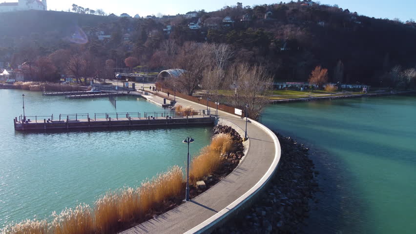 Angled aerial of curving pier and Tihany ferry waiting area with clean seating rows