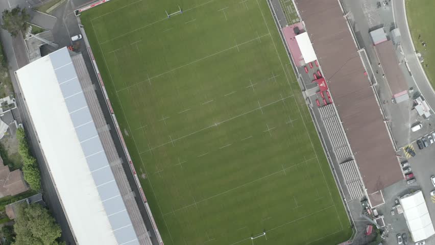 Rugby pitch, empty Parc des Sports Aguilera stadium, Biarritz, France. Aerial top-down descending